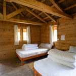 Eco‑friendly lodge room with rustic wooden decor and Himalayan mountain views at Kalsee Eco Lodge.